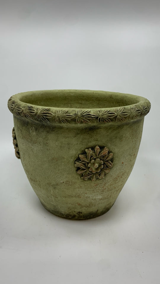 GREEN CEMENT PLANTER W/EMBOSSED FLOWERS.