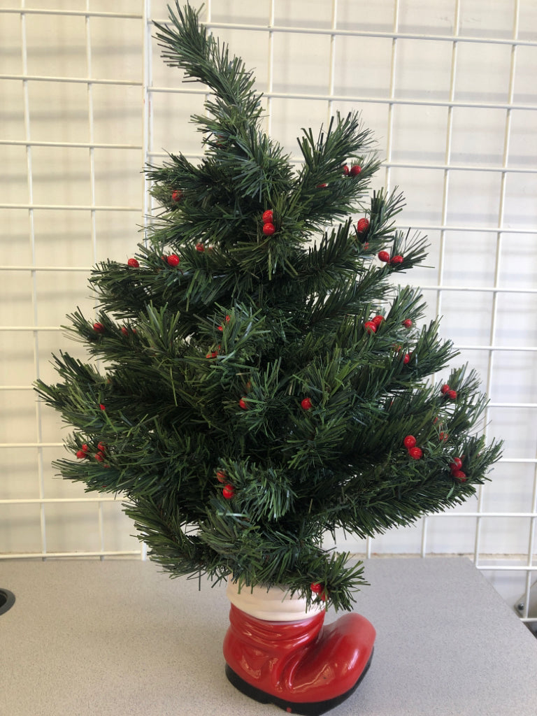 FAUX TREE W/BERRIES IN SANTAS BOOT.