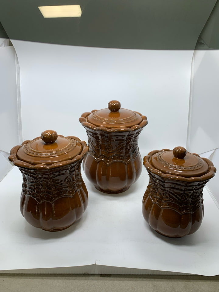 3 LIGHT BROWN SCROLL DETAILED CANISTERS.