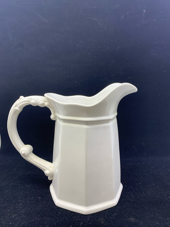 WHITE CERAMIC PITCHER W/DECORATIVE HANDLE.