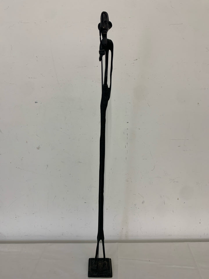 TALL BLACK METAL MAN FIGURE HOLDING A STAKE.