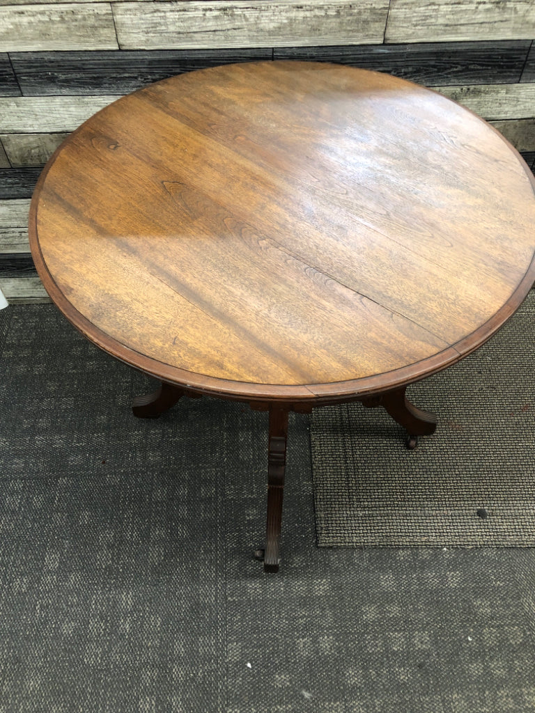 VTG DARK WOOD ROUND END TABLE ON WHEELS.