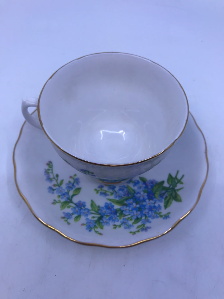 VTG TEA CUP AND SAUCER W/ BLUE FLOWERS AND GOLD RIM.