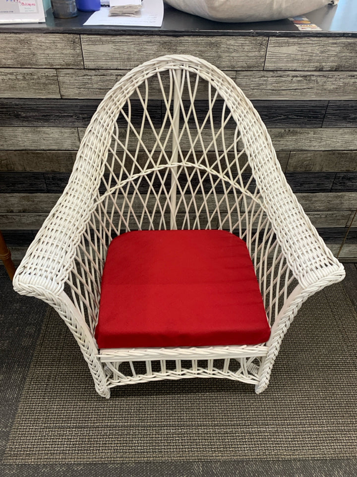 LOW WICKER WOVEN CHAIR W/ RED CUSHION.