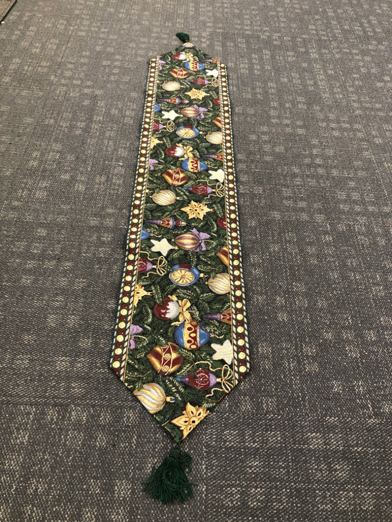 GREEN TABLE RUNNER WOVEN W/ COLORFUL ORNAMENTS.