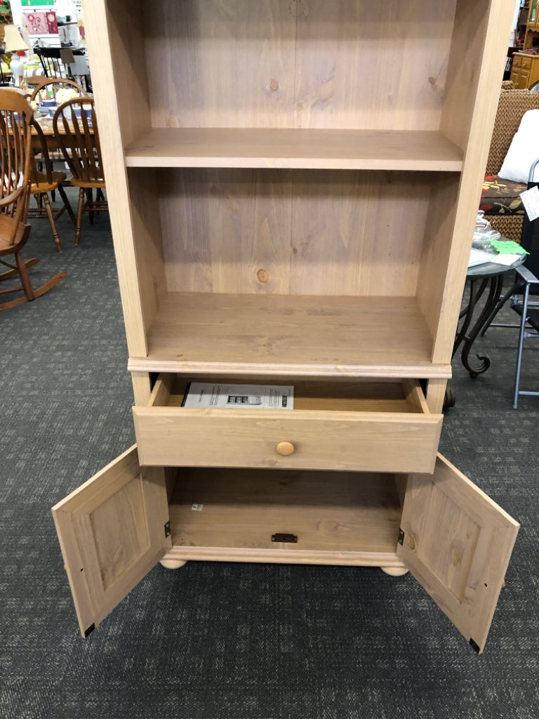 BLONDE WOOD LIBRARY SHELF W/DOORS.