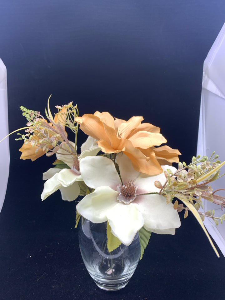 ORANGE AND CREAM FLORAL IN CLEAR VASE W FAUX WATER.