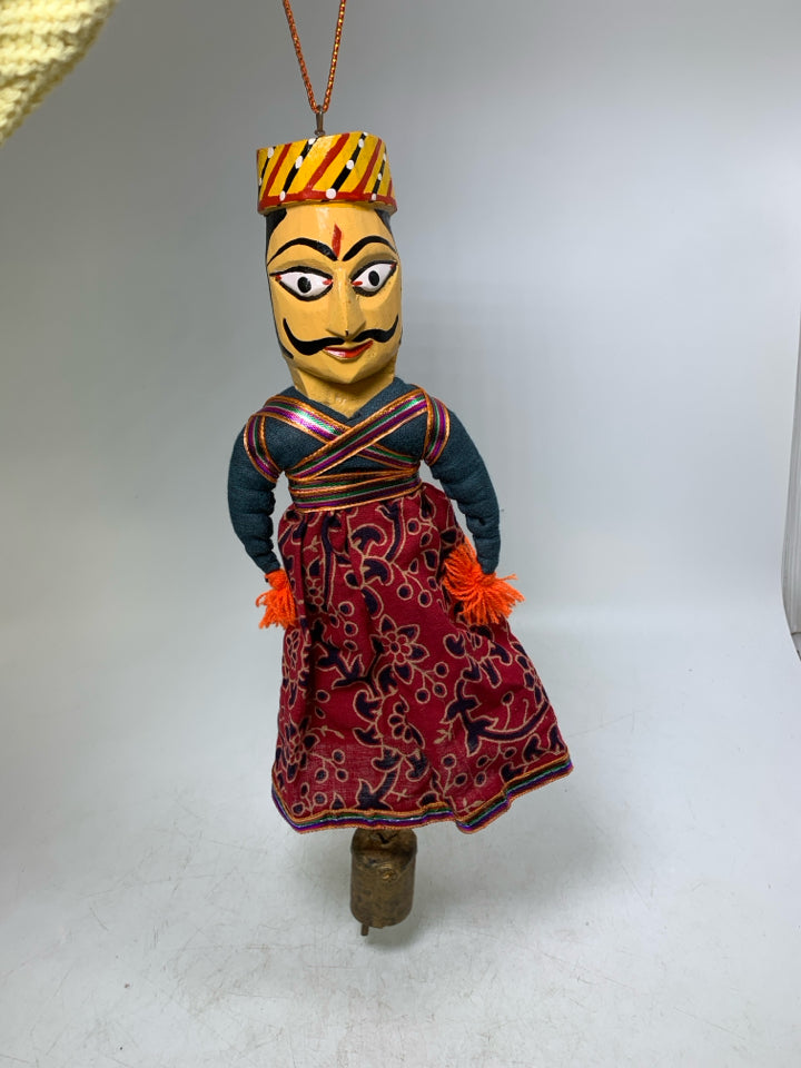 MAN W/ MUSTACHE DRESS ON WALL HANGING W/ BELL.