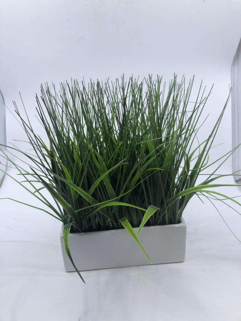 FAUX GRASS IN WHITE PLANTER.