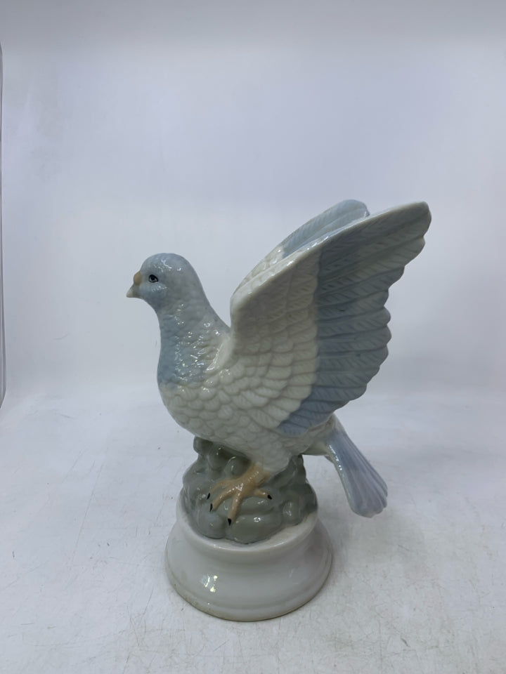 CERAMIC PIGEON ON ROCKS.