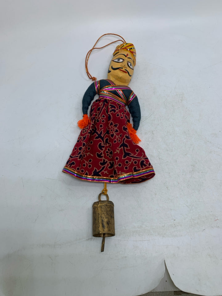 MAN W/ MUSTACHE DRESS ON WALL HANGING W/ BELL.