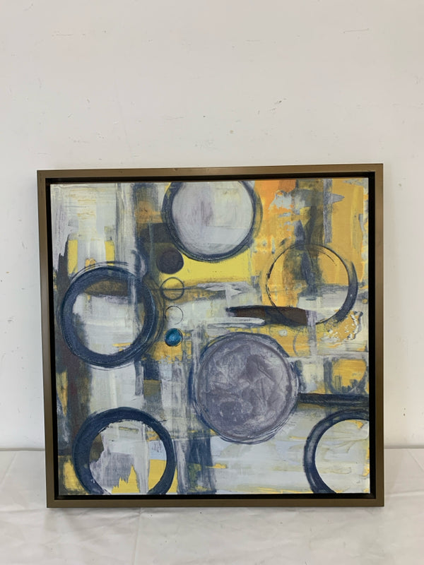 BLUE AND YELLOW CIRCLE ABSTRACT WALL HANGING IN BROWN FRAME.