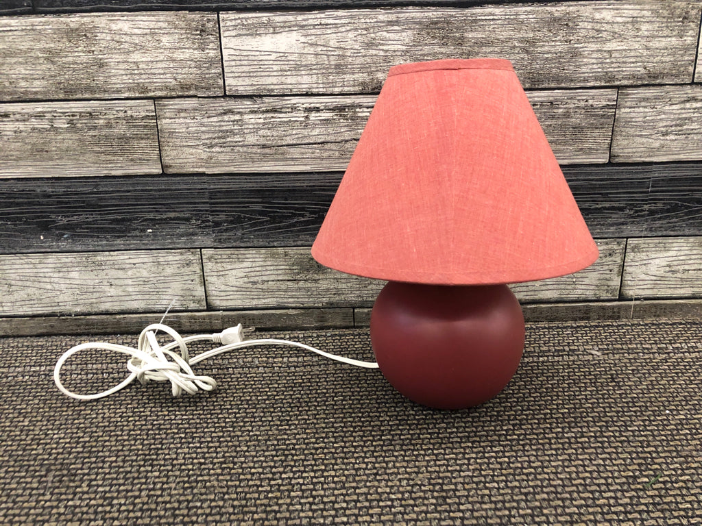 RED METAL CIRCLE BASE LAMP W/ RED SHADE.