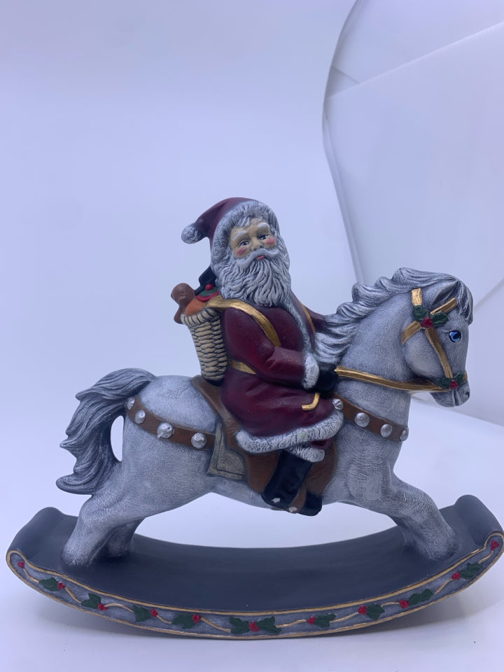 SANTA ON GRAY ROCKING HORSE.