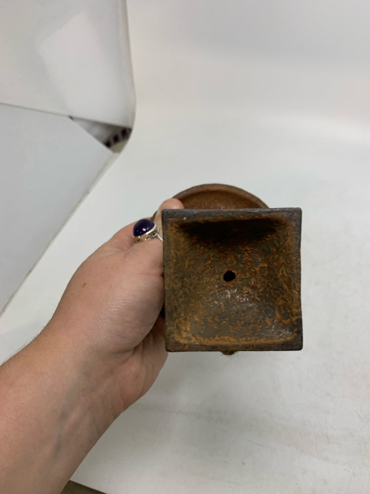 RUSTED HEAVY METAL FOOTED VASE.