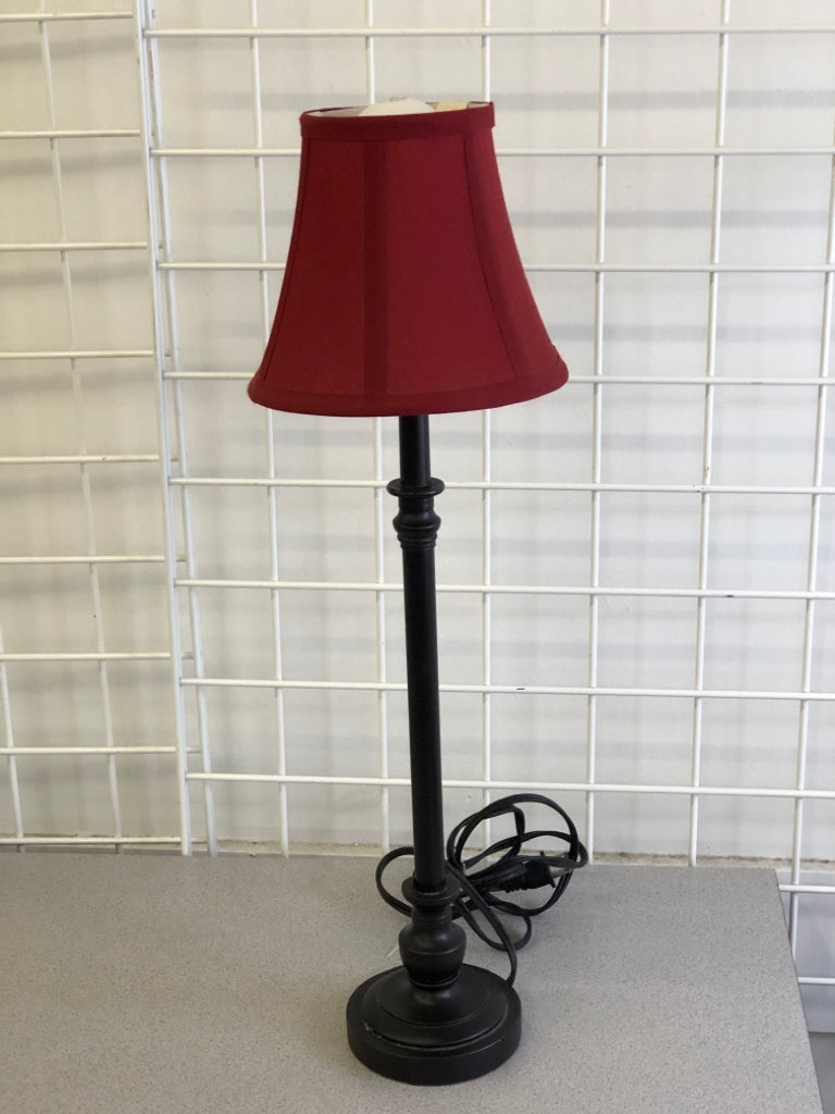 SKINNY BLACK BASE LAMP W/ RED SHADE.