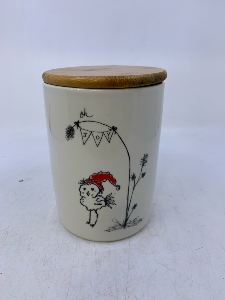 ILLUSTRATION OF BIRD W/ RED HAT OH JOY HANGING FROM TREE.