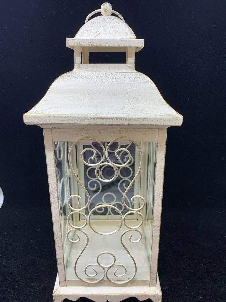 DISTRESSED WHITE LANTERN CANDLE HOLDER W/CURLED WIRE SIDES & CIRCLE HANDLE.