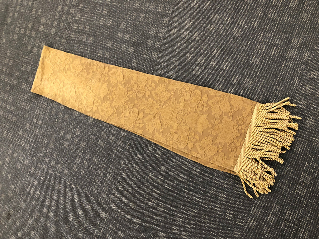 BROWN TABLE RUNNER W/DAMASK PATTERN+GOLD TASSELS.