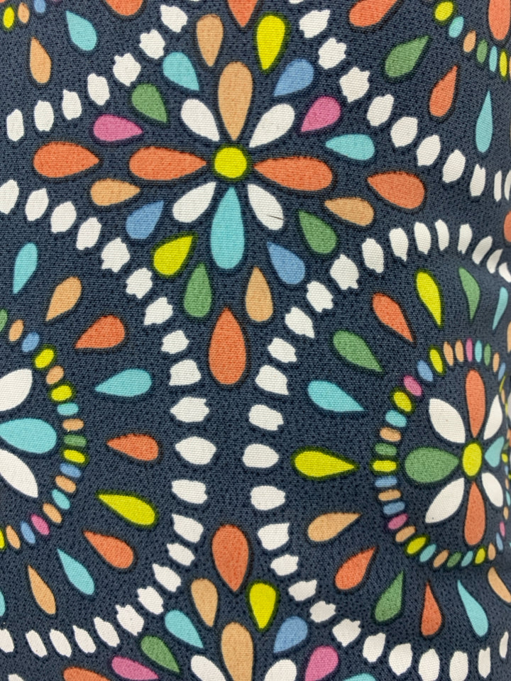 BLUE PILLOW W/RAINBOW MANDALA PATTERN.