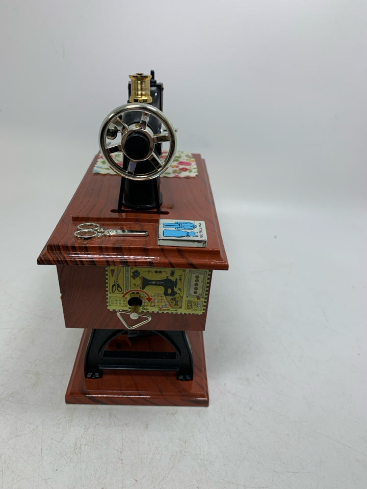 PLASTIC SEWING TABLE W/ MACHINE MUSIC BOX MOVING PIECES.