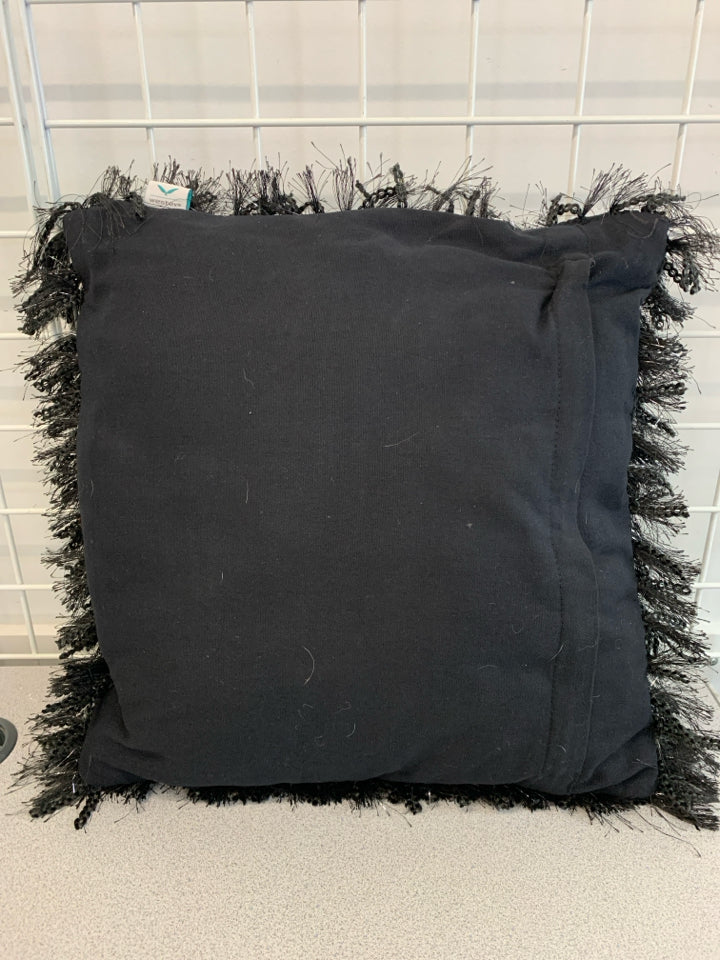 BLACK FURRY PILLOW W/TINSEL ACCENTS.