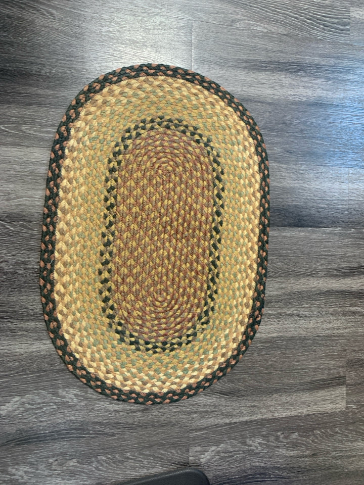 OVAL BRAIDED RUG.
