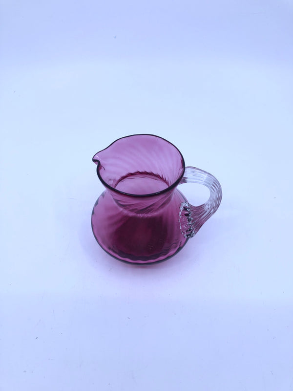 PINK BLOWN GLASS PITCHER W/ RIBBED DESIGN.