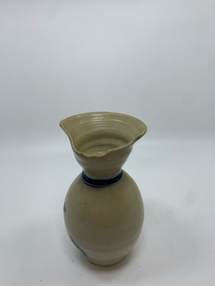 TAN STONEWARE SALT GLAZE PITCHER W/BLUE GLAZED FLORAL DESIGN.