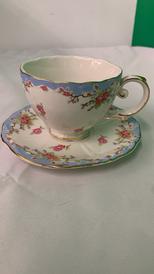 LIGHT BLUE W PINK FLORAL TEACUP AND SAUCER.