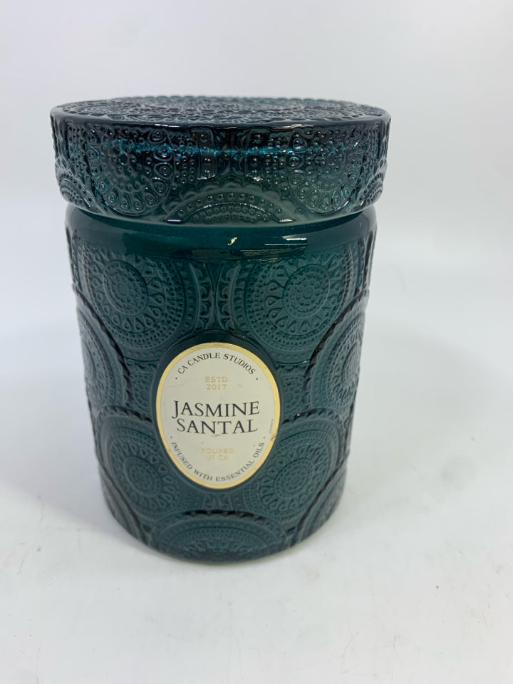 JASMINE SANTAL CANDLE IN GREEN GLASS JAR.
