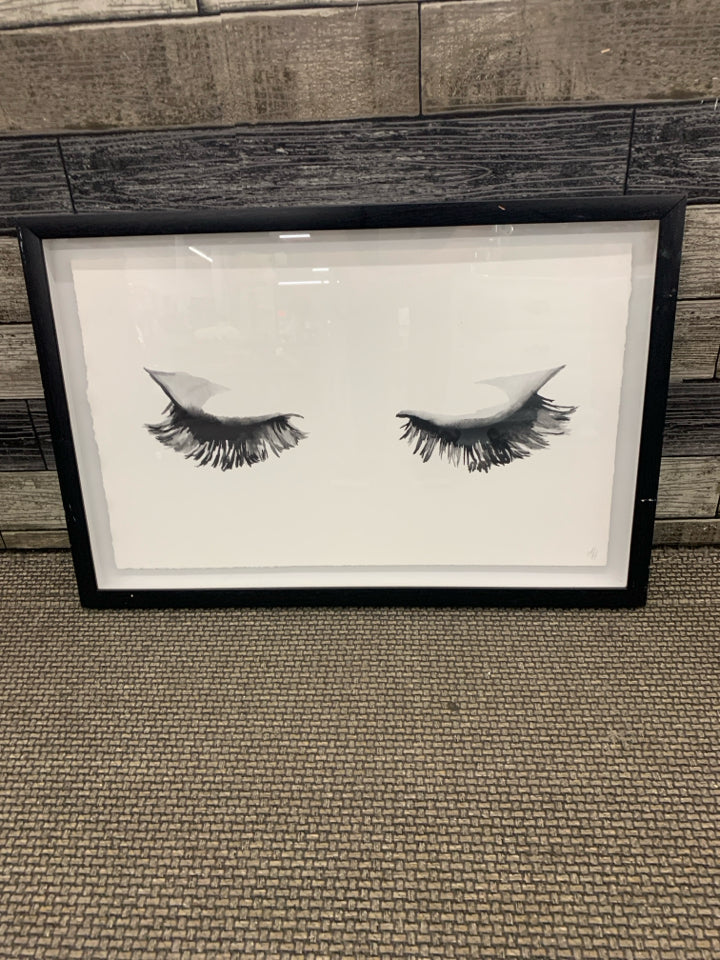 EYELASHES IN BLACK FRAME WALL HANGING.