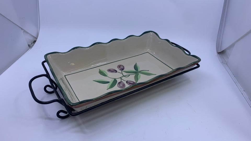 OLIVE CASSEROLE DISH IN METAL HOLDER.