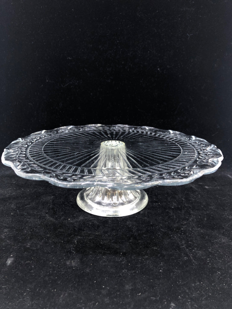 RAISED GLASS CAKE STAND W/SCALLOPED EDGE.
