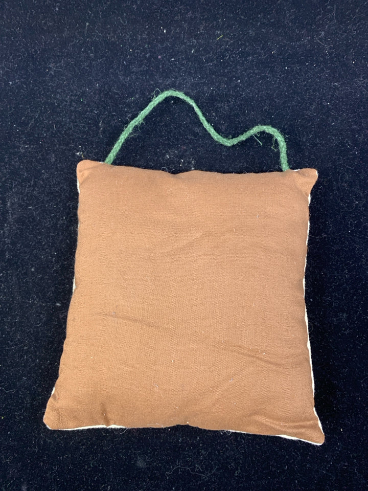 EMBROIDERED WELCOME PILLOW.