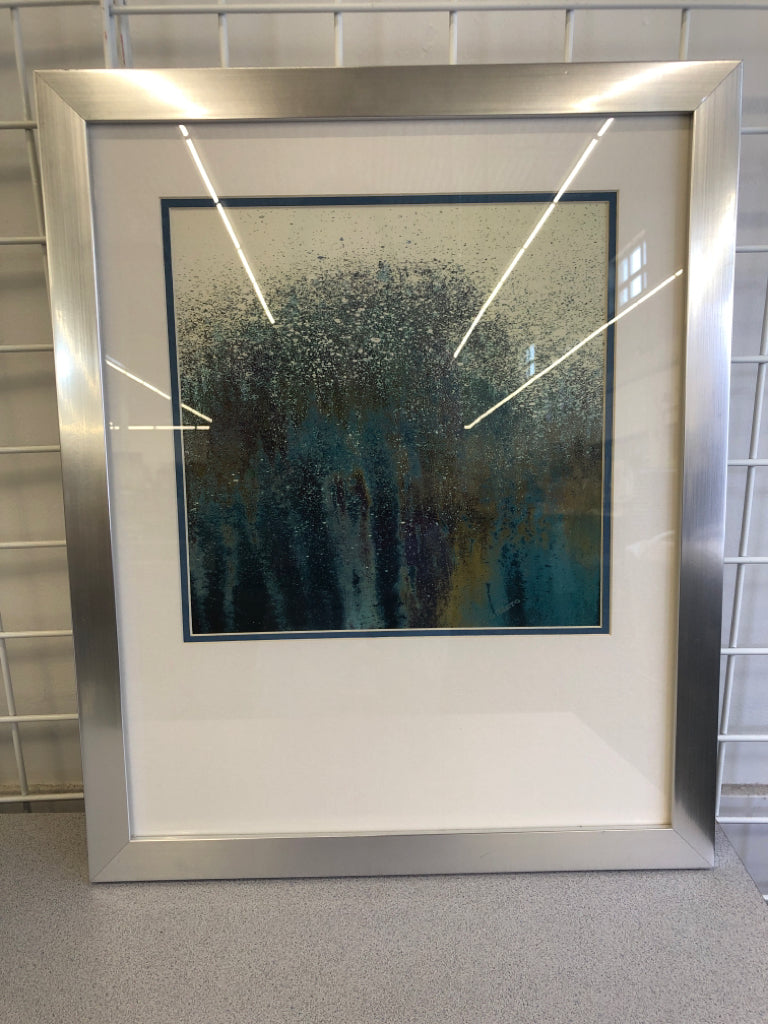 BLUE SPLATTER ART IN SILVER FRAME.