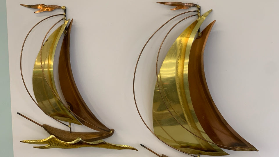 BRONZE METAL SHIPS MOUNTED ON GOLD FRAME.