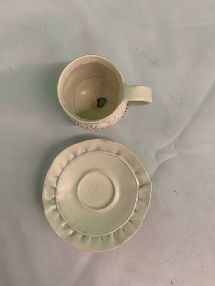 HANDMADE POTTERY EMBOSSED TEACUP AND SAUCER.