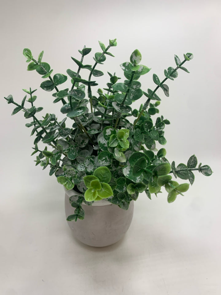 FAUX GREENS IN CEMENT POT.