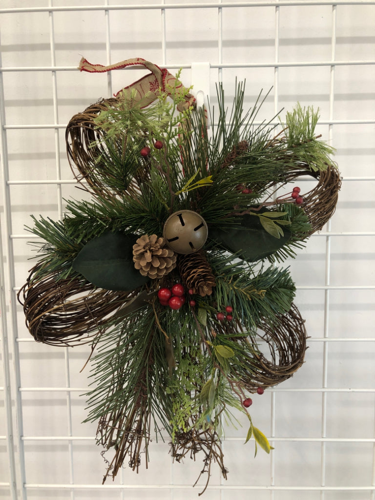 BOW SHAPED WREATH WITH GREENERY AND STARS.