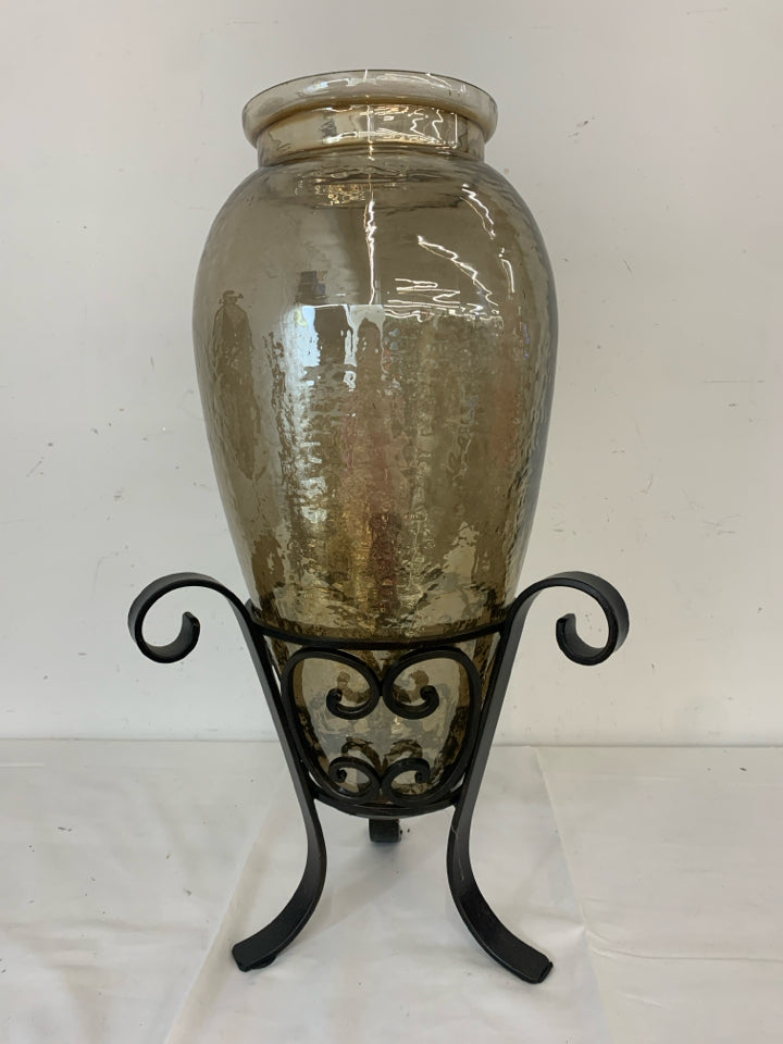 HEAVY GLASS VASE IN METAL STAND.