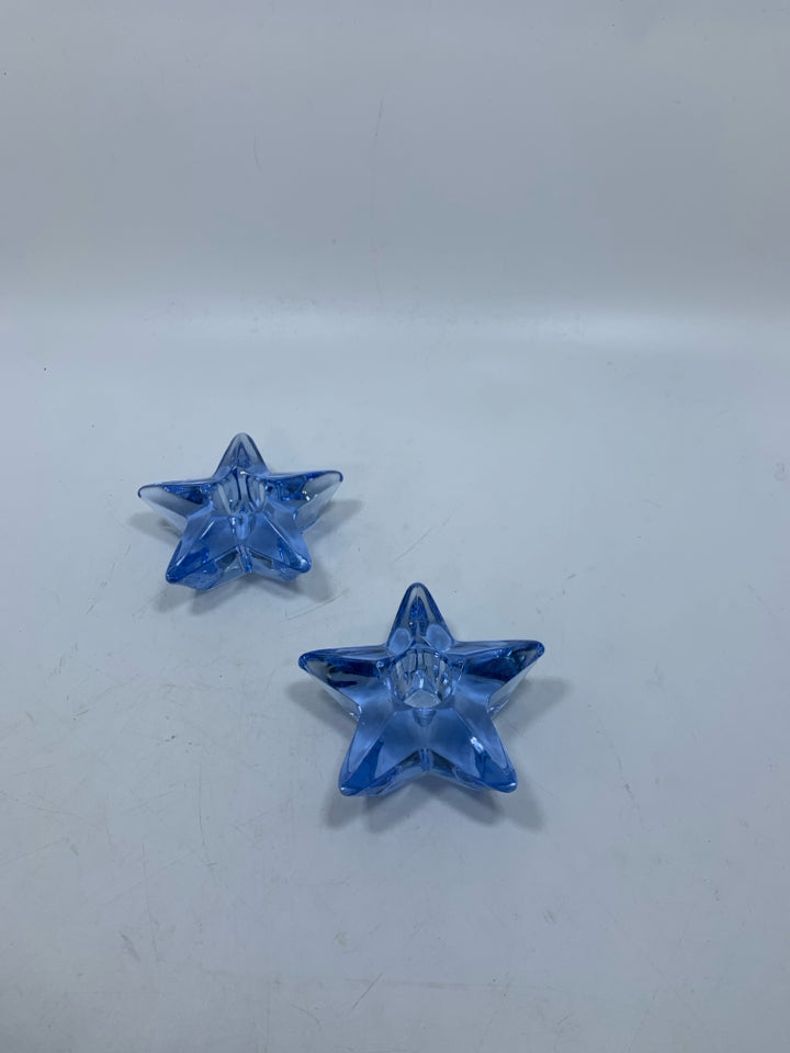 2 LIGHT BLUE STAR SHAPED GLASS TAPERED CANDLE HOLDERS.