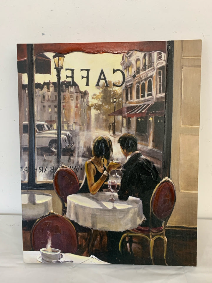 COUPLE SITTING IN A CAFE LOOKING OUT THE WINDOW W/ WINE CANVAS.