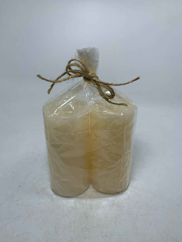 NIP 2 CREAM COLORED PILLAR CANDLES.