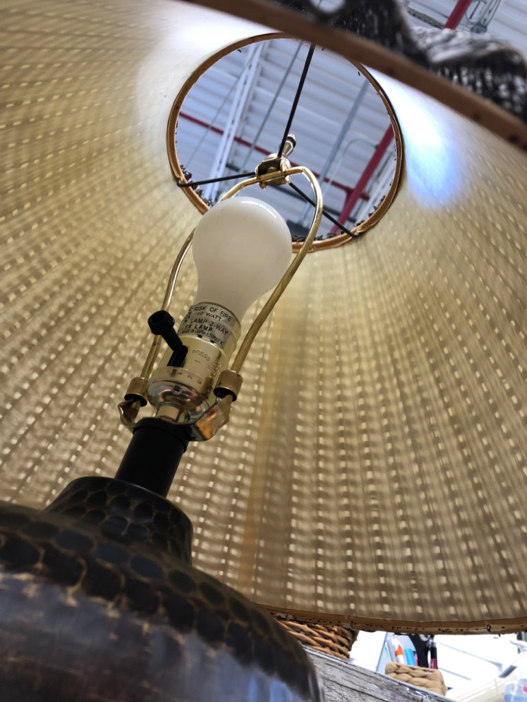 BRONZE BASE LAMP W/BROWN WICKER SHADE.
