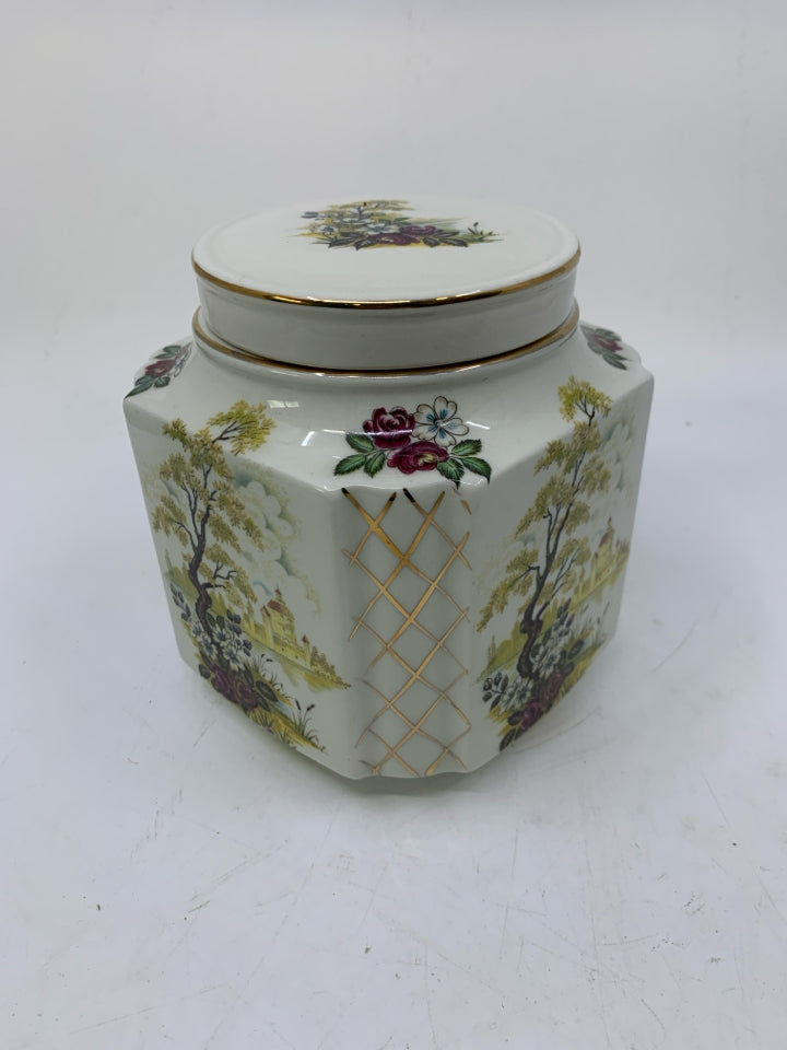 VTG WHITE SQUARE GINGER JAR W/ POND SCENE LOOKING OUT TO HOUSE GOLD DETAILS.