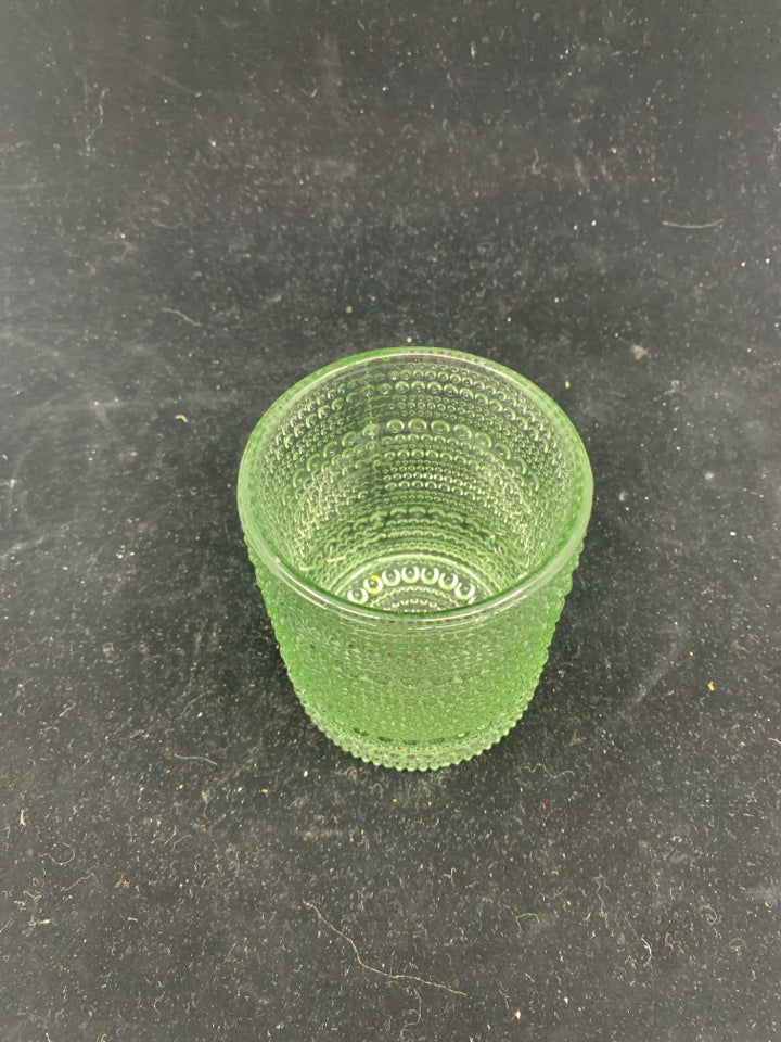 GREEN TINTED TEXTURED GLASS CANDLE HOLDER.