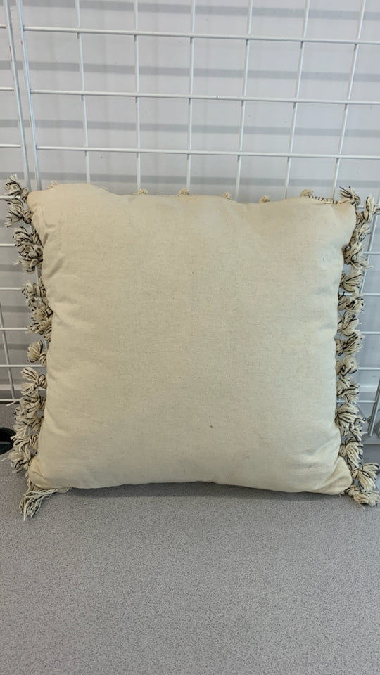 TAN ACCENT PILLOW W/KNIT BALLS AND TASSELS.