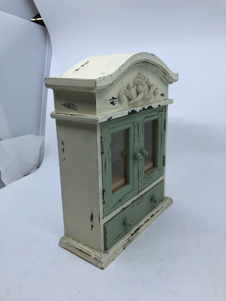 SMALL DISTRESSED PAINTED CABINET MINT GREEN+WHITE W/ SCROLL DESIGN.