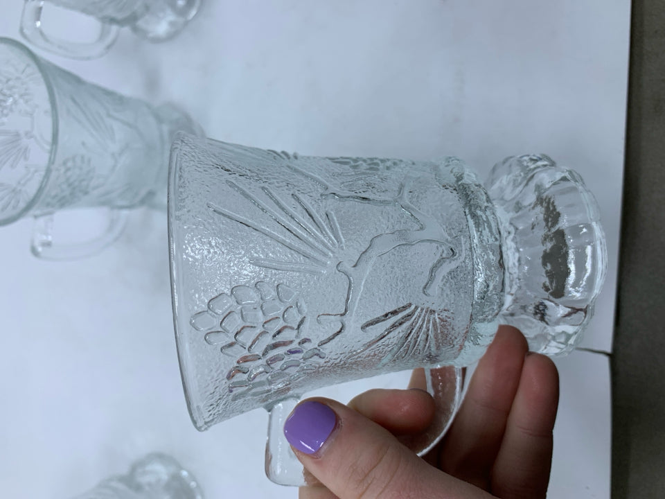 4 CLEAR FOOTED GLASS MUGS W/ EMBOSSED PINECONES.